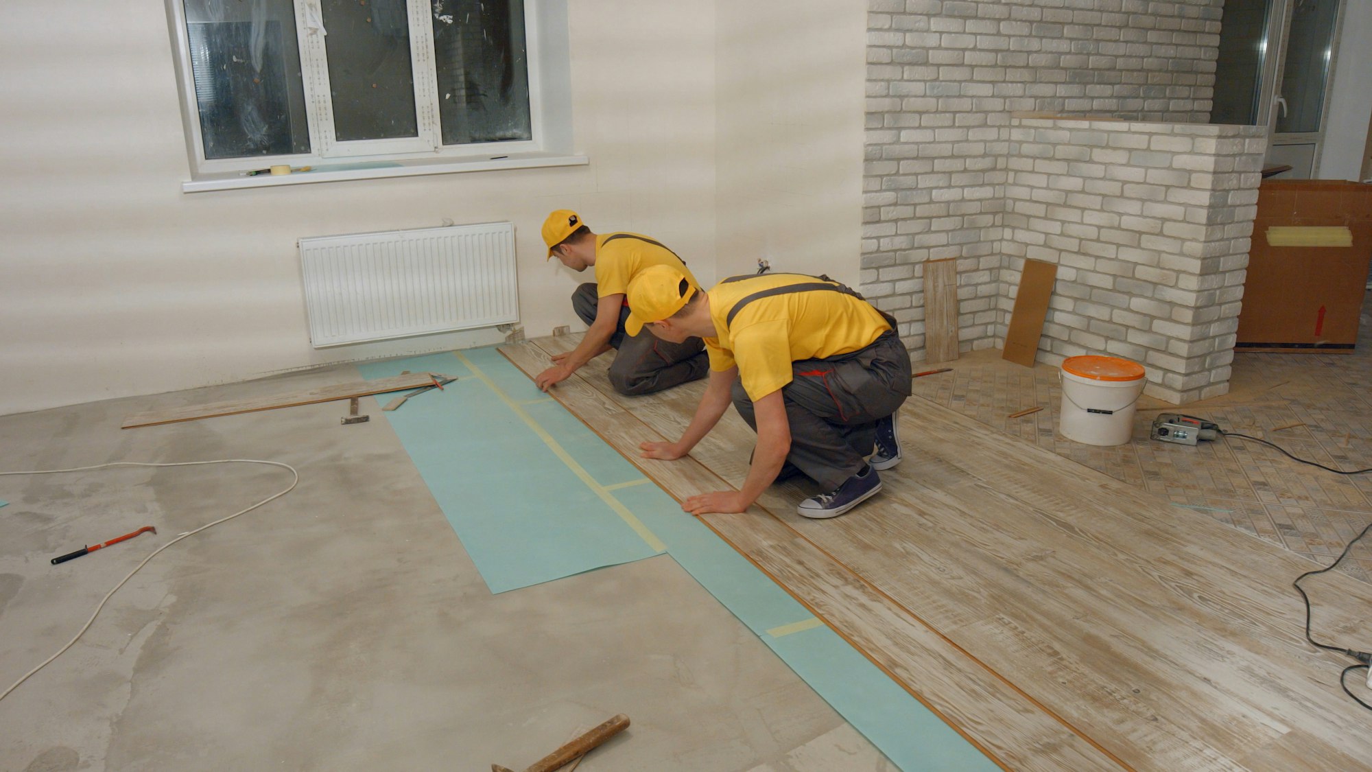 Laying parquet board in the apartment.